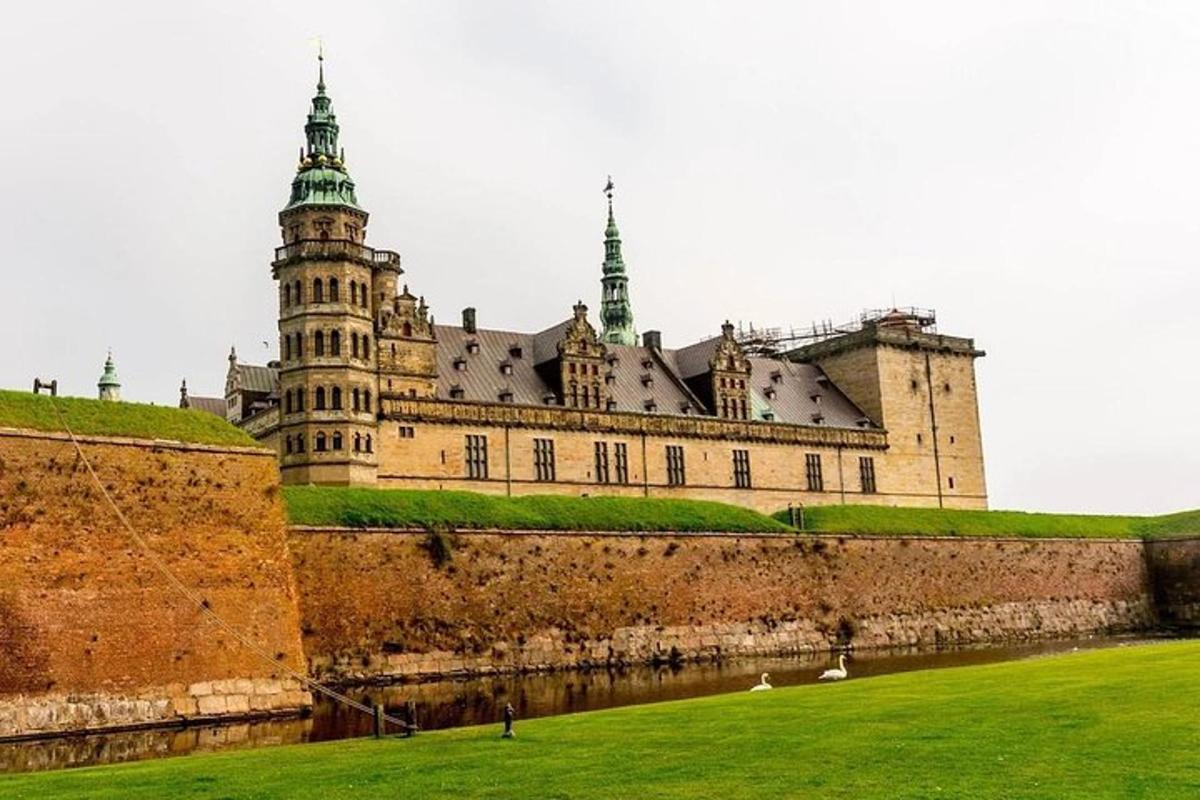 a large castle with a green field in front of it