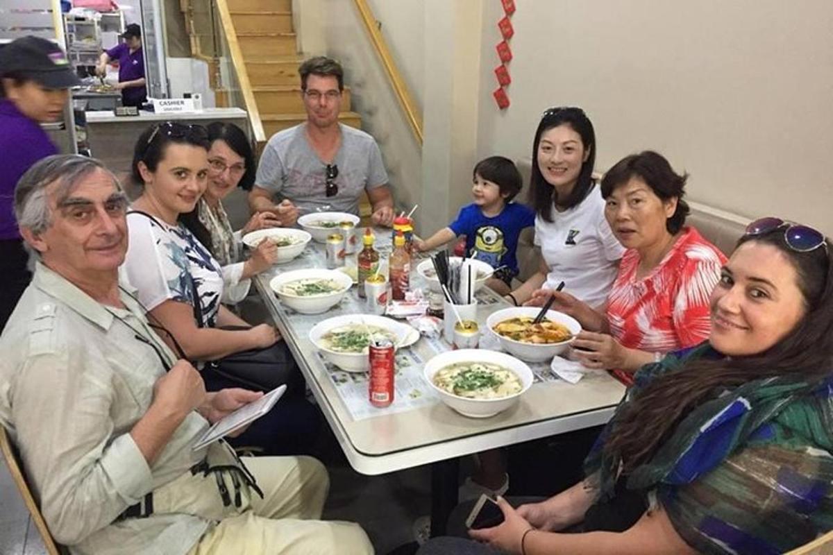 a group of people sitting around a table eating food