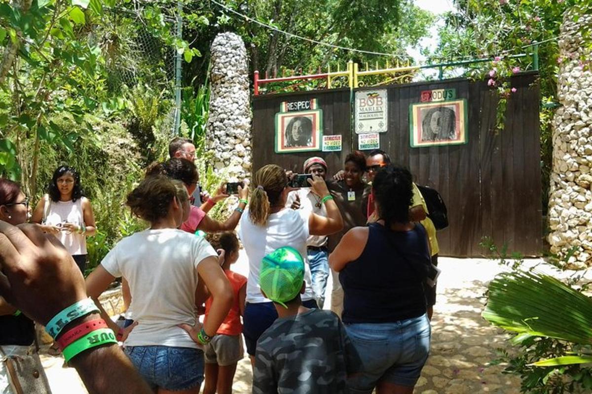 a group of people standing in front of a fence