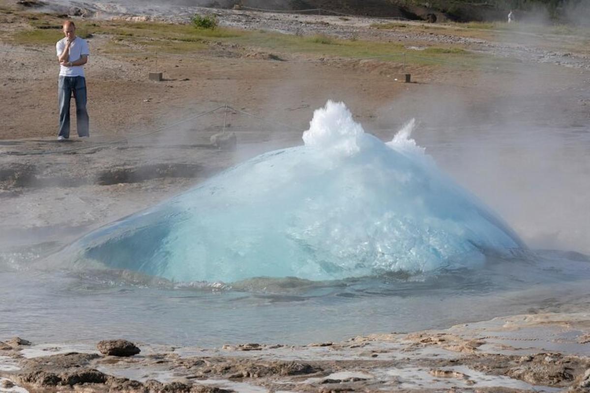 a person standing in front of a geyser