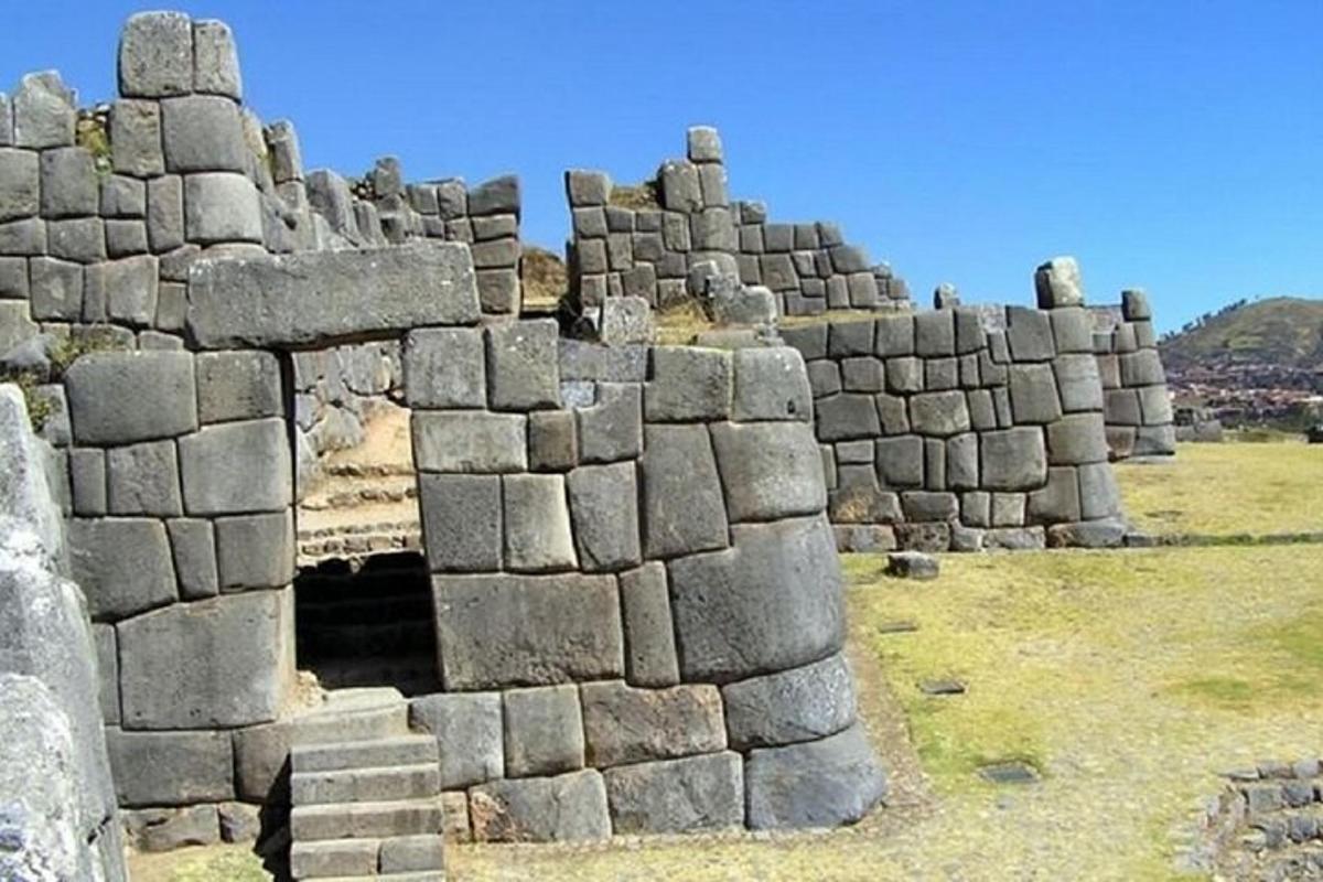 a group of stone buildings in a field