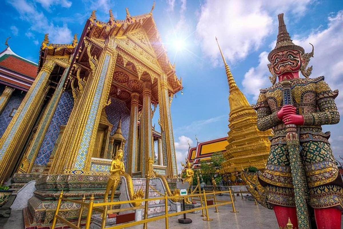 a statue in front of a golden temple