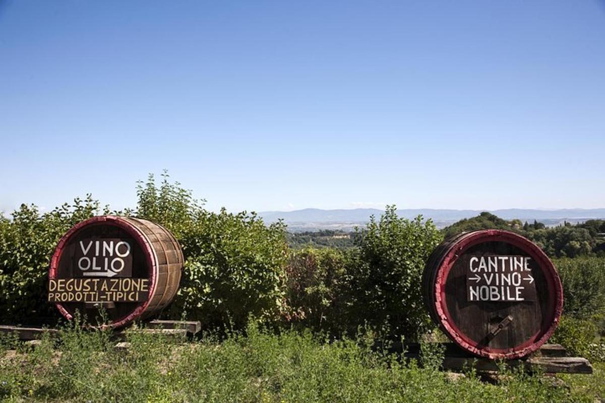 two signs for a winery in a field