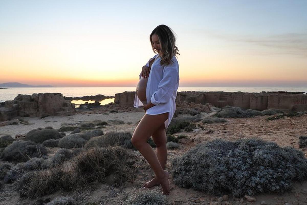 a woman in a white shirt standing in the desert