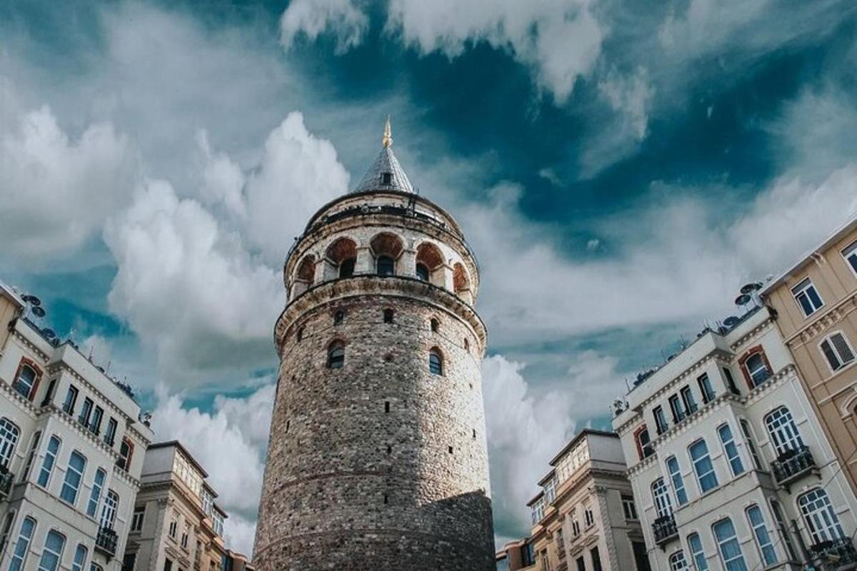a tall brick building with a tower in a city