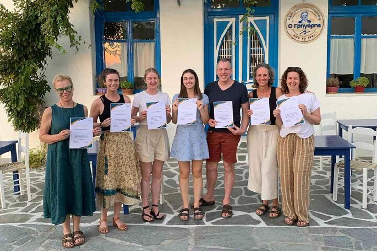 a group of people posing for a picture holding certificates