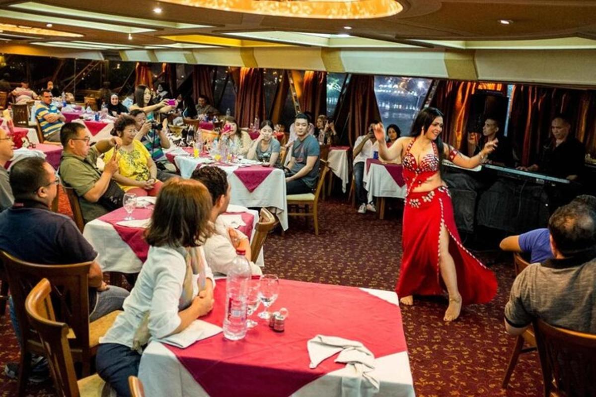 Una mujer con un vestido rojo está parada en un restaurante.