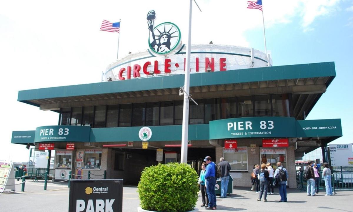 a group of people standing outside of a ballpark