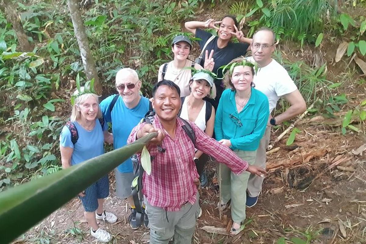 a group of people posing for a picture in the woods