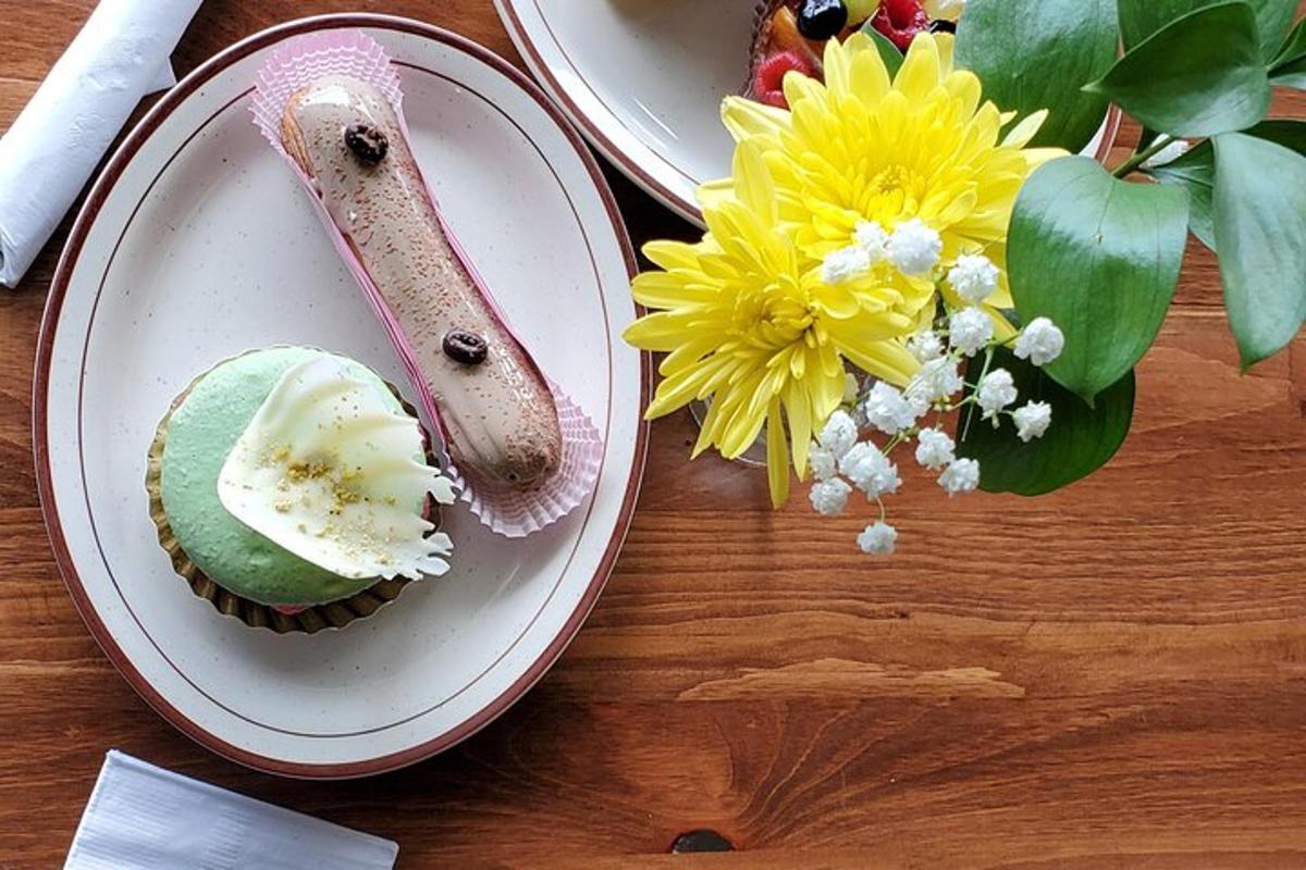 a table with a cupcake on a plate with a knife