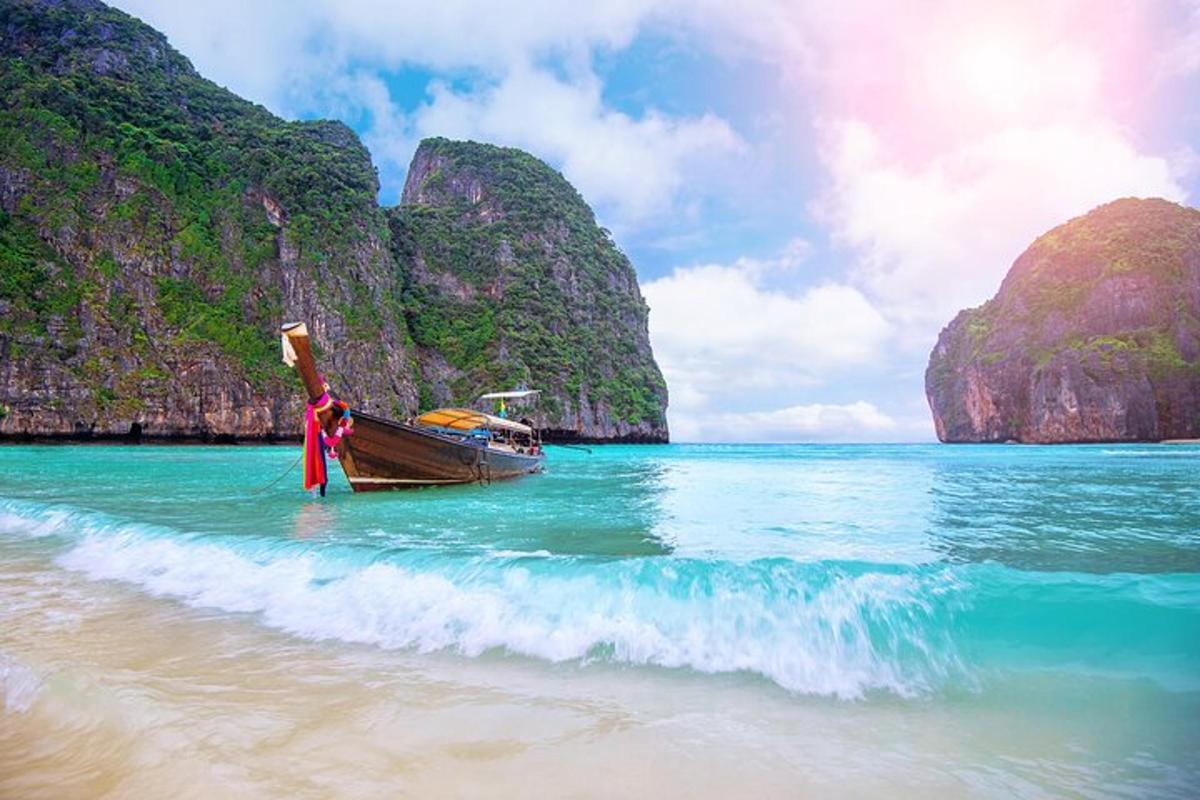 a boat in the water on a beach with mountains