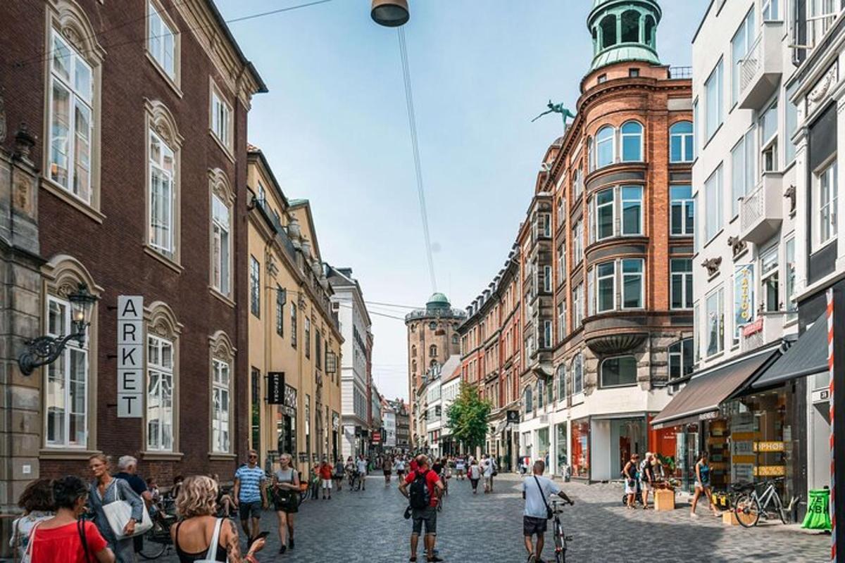 a group of people walking down a street with buildings