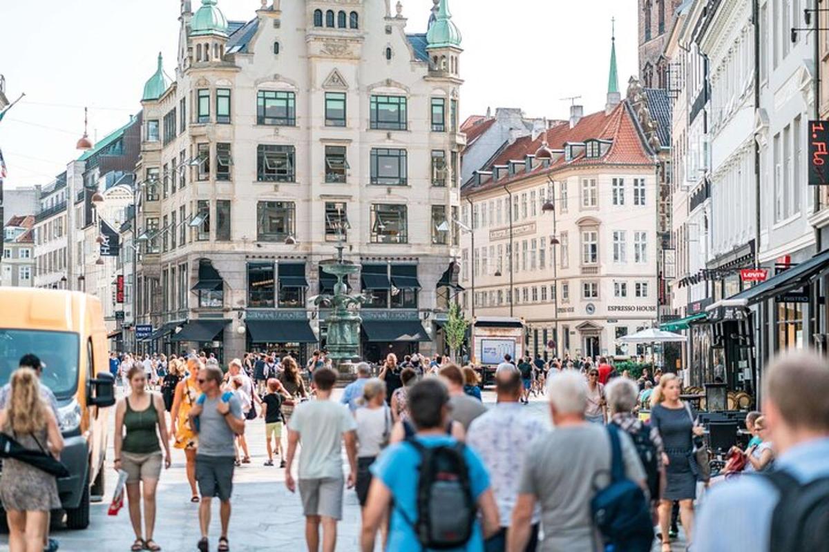 a crowd of people walking down a busy city street