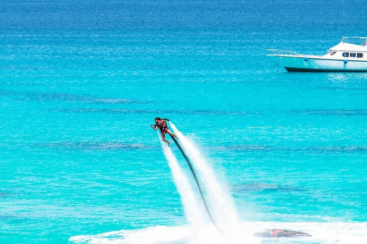 a person water skiing in the water with a boat
