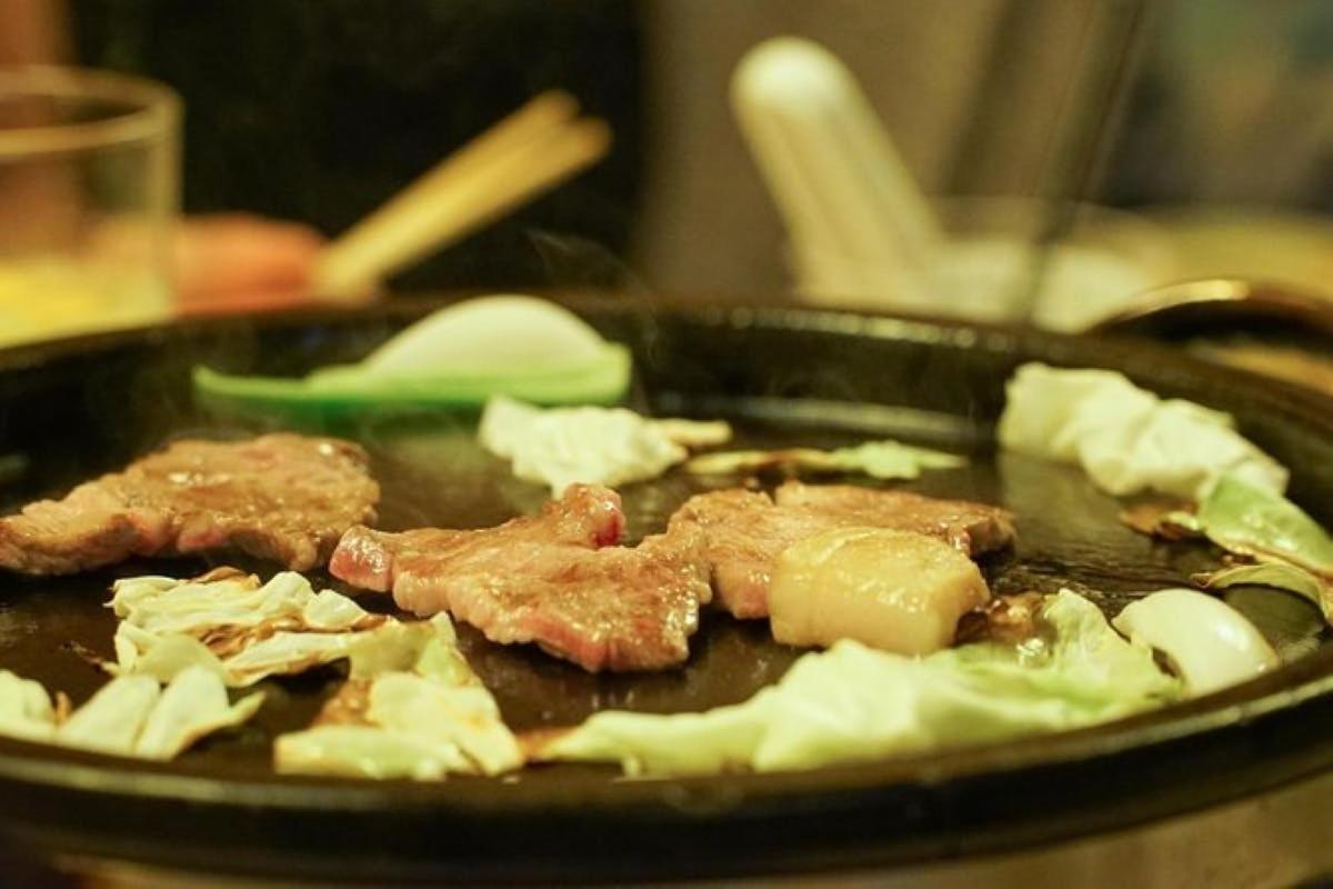 a pan of food with meat and vegetables in it