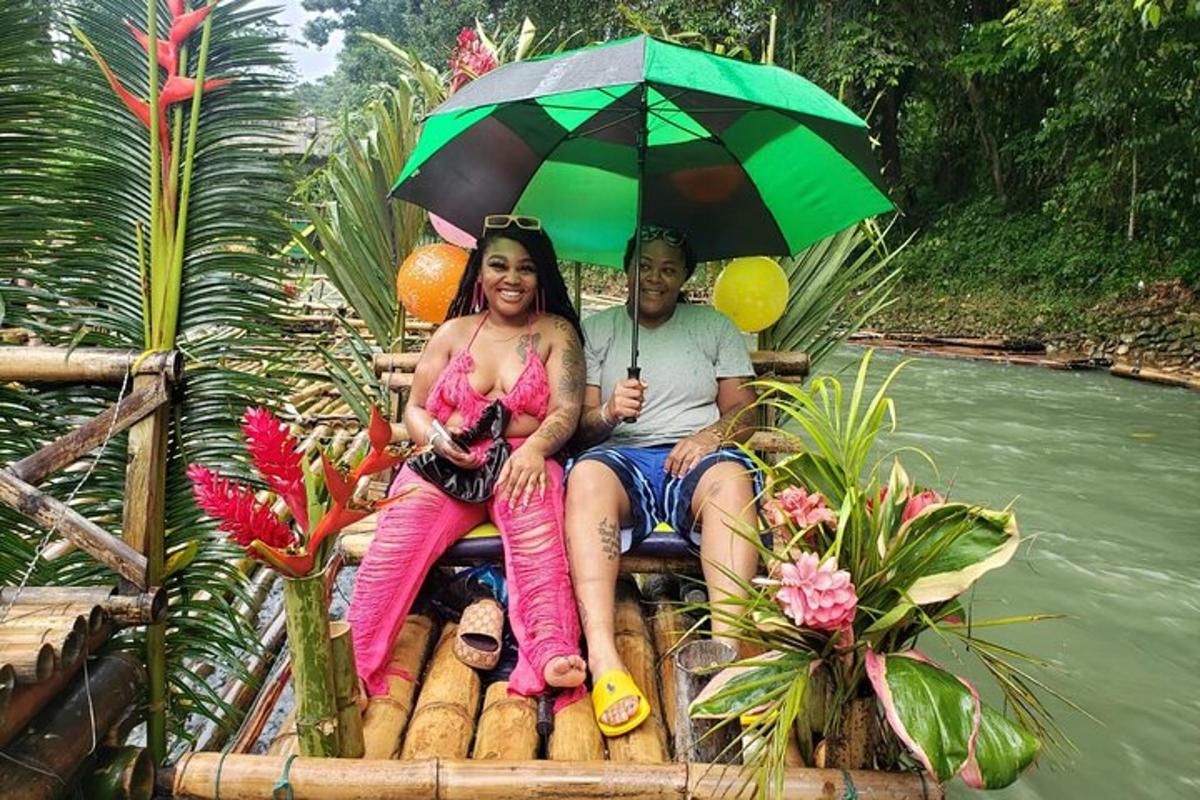 a man and a woman sitting on a raft with an umbrella