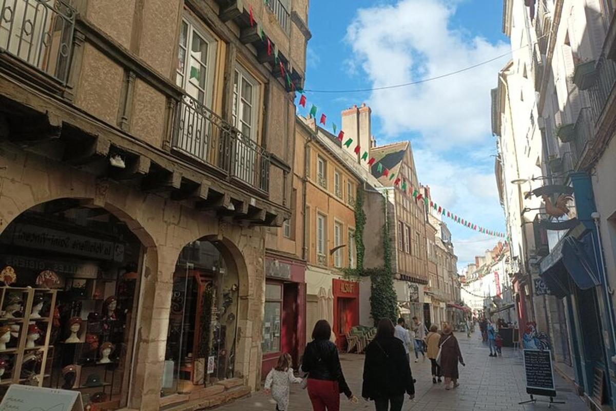 a group of people walking down a street with buildings