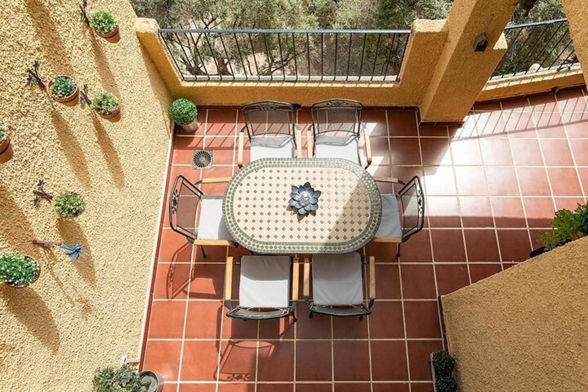 an overhead view of a table and chairs on a patio