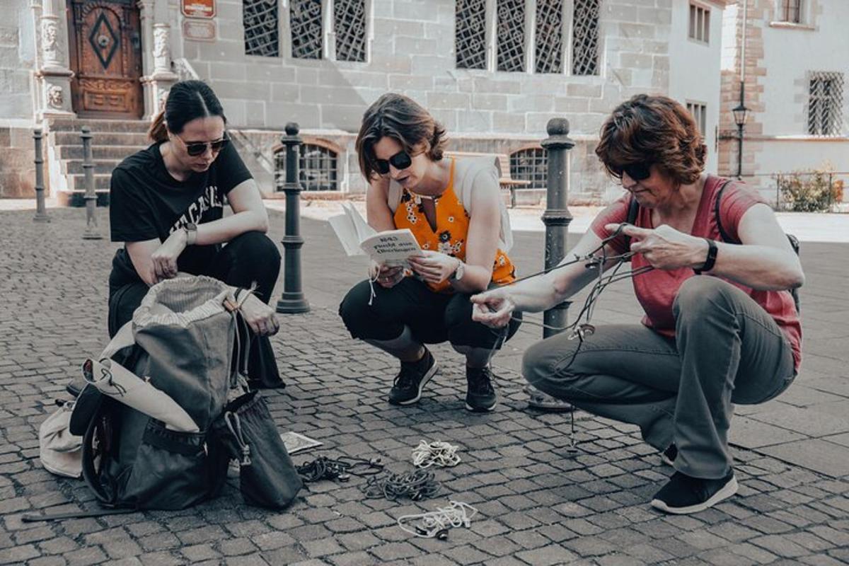 three men sitting on the ground looking at their cell phones