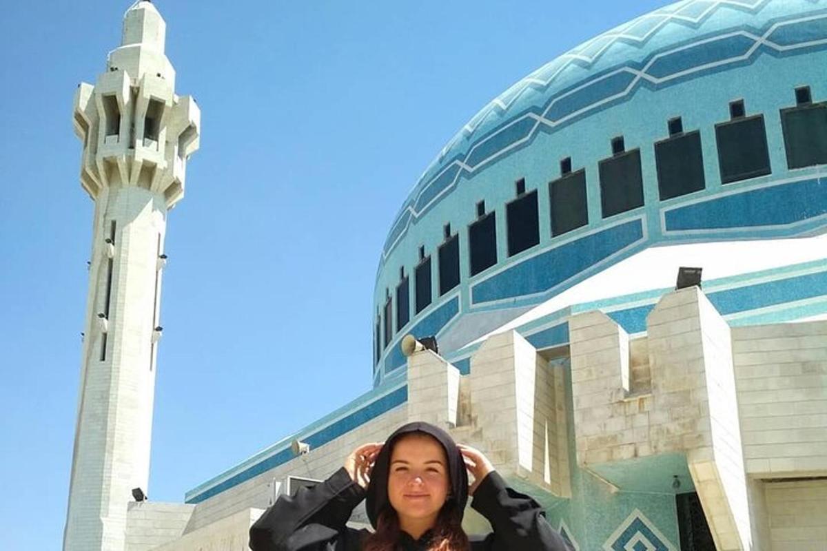 a woman is standing in front of a building