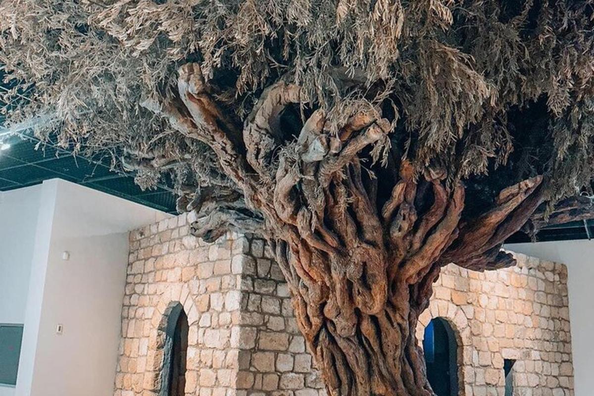 a large uprooted tree in front of a brick wall