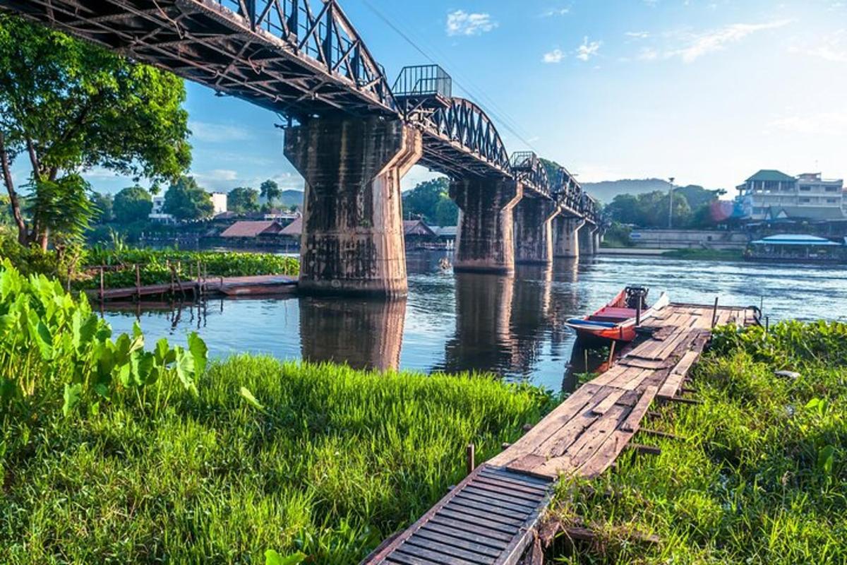 a bridge over a river with a boat under it