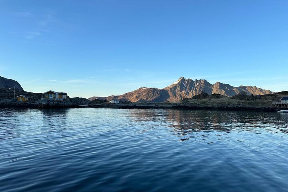 a large body of water with mountains in the background