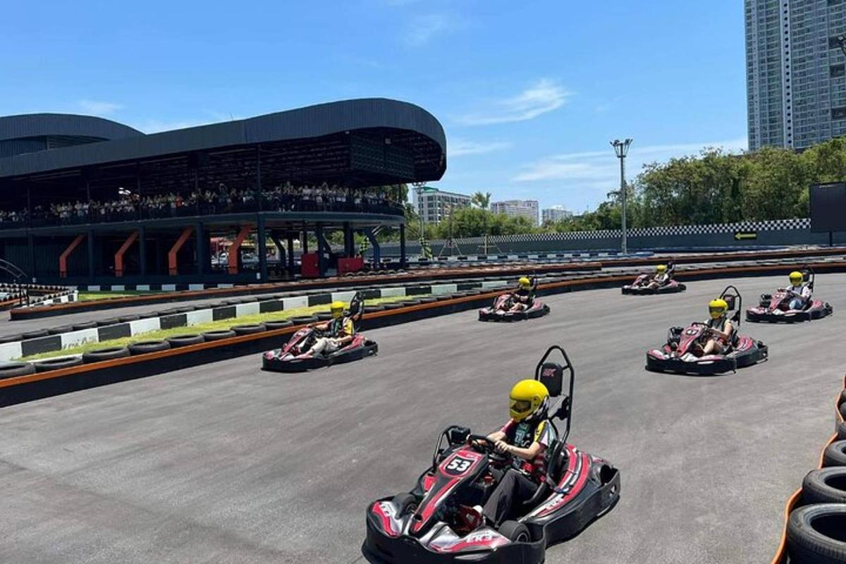 a group of people riding down a race track on a motorcycle