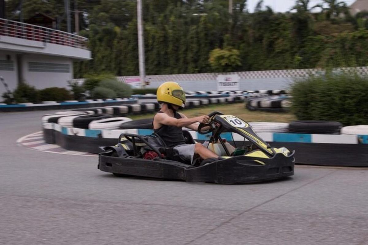 a man riding a go cart on a race track