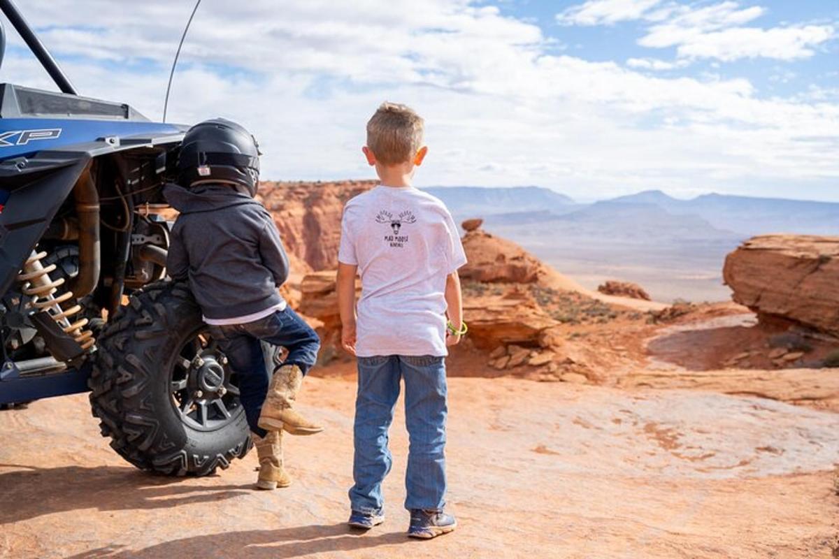 two young boys standing on top of a motorcycle