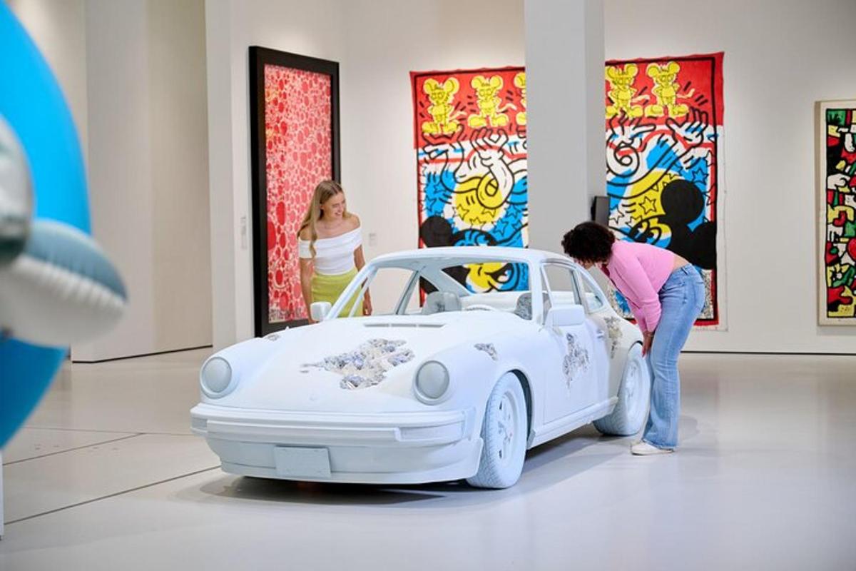 a woman is standing next to a white car