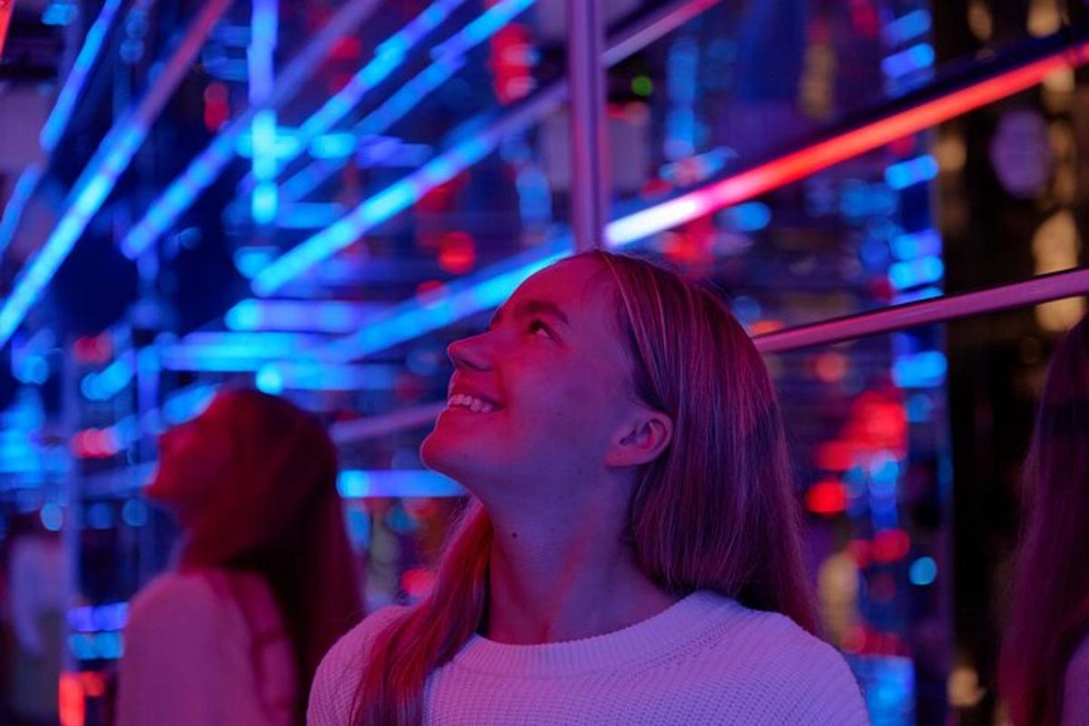 a woman standing in front of a ferris wheel
