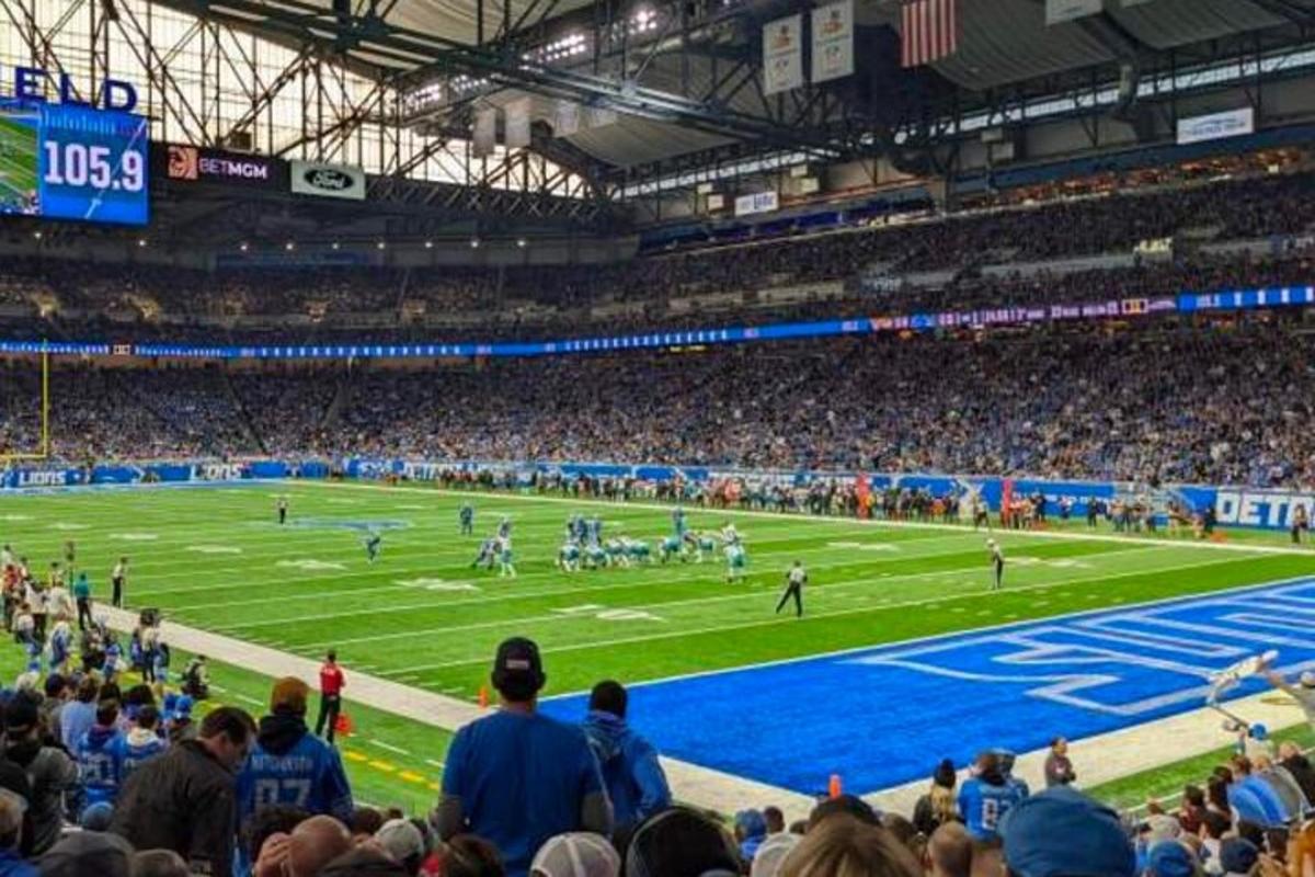 a crowd of people watching a football game in a stadium