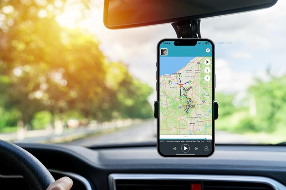 a cell phone hanging from a car dashboard