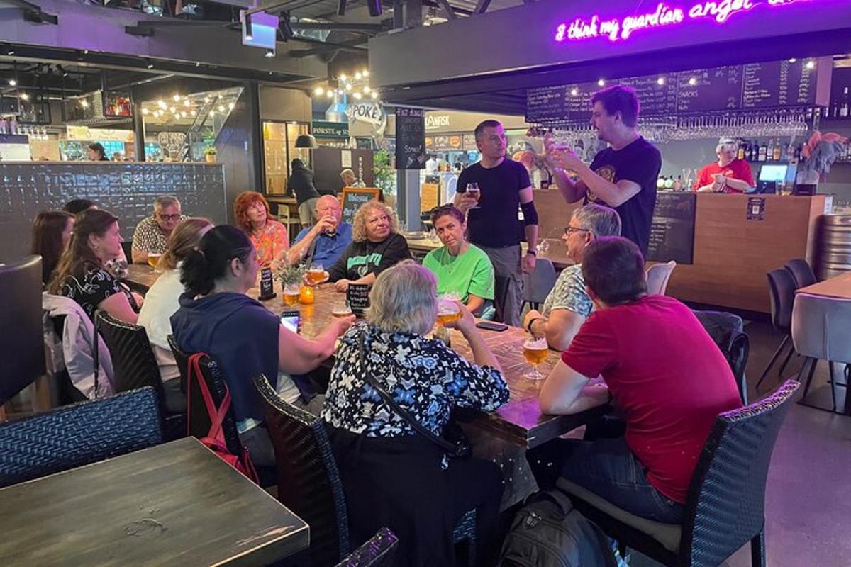a group of people sitting at tables in a restaurant