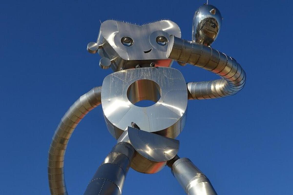 a metal pole with a robot on top of it