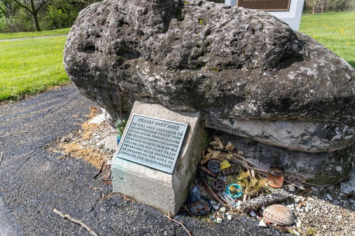 a statue of a rock next to a grave