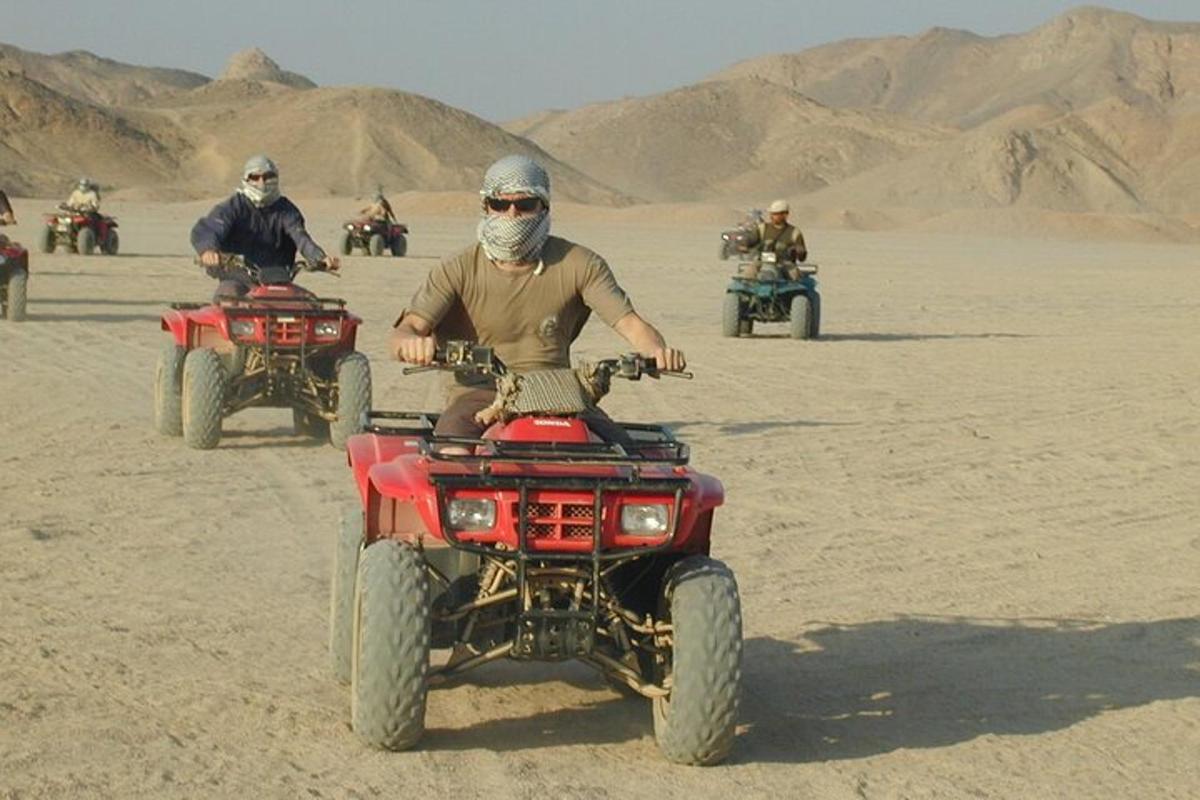 a man on a four wheeler in the desert