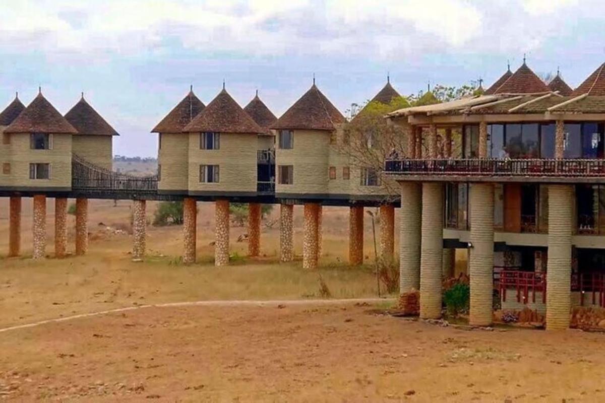 a row of houses on pillars in the desert