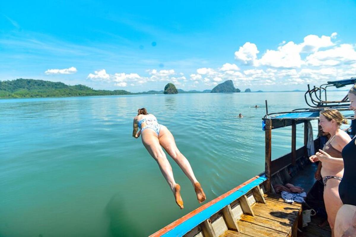 a woman jumping off a dock into the water