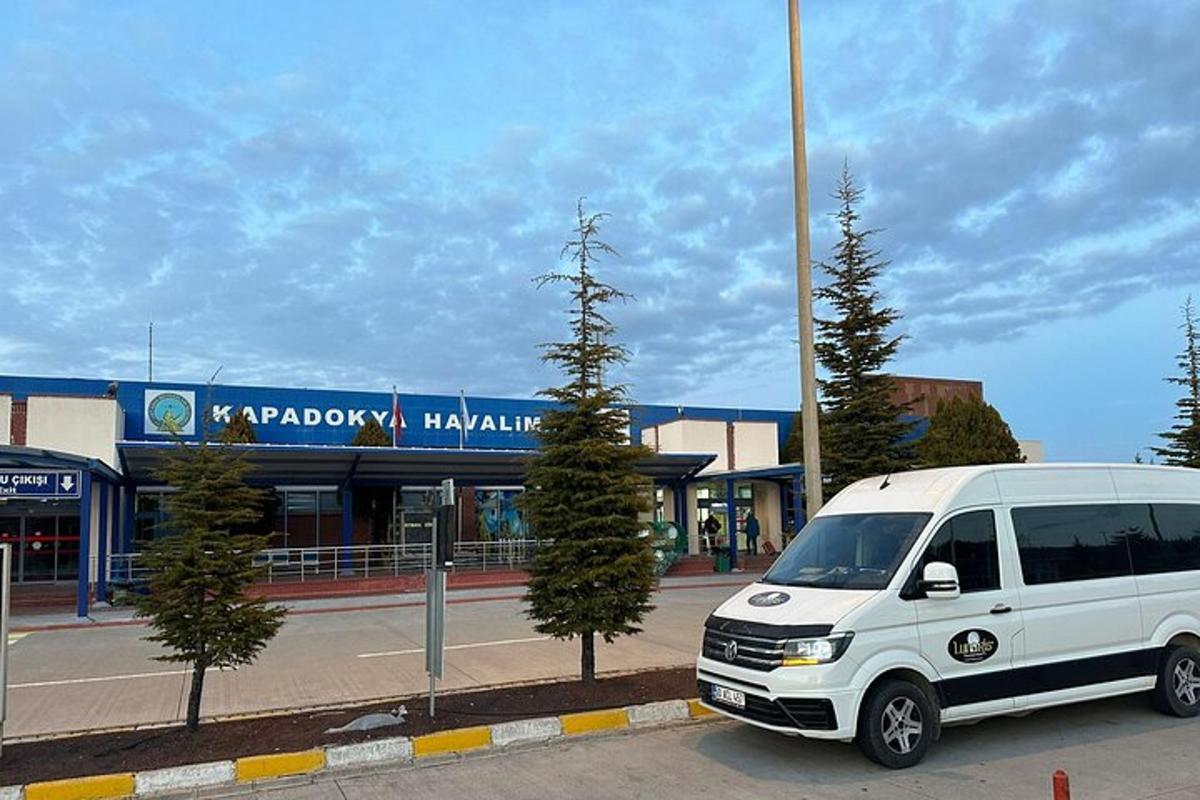 a white van parked in front of a building