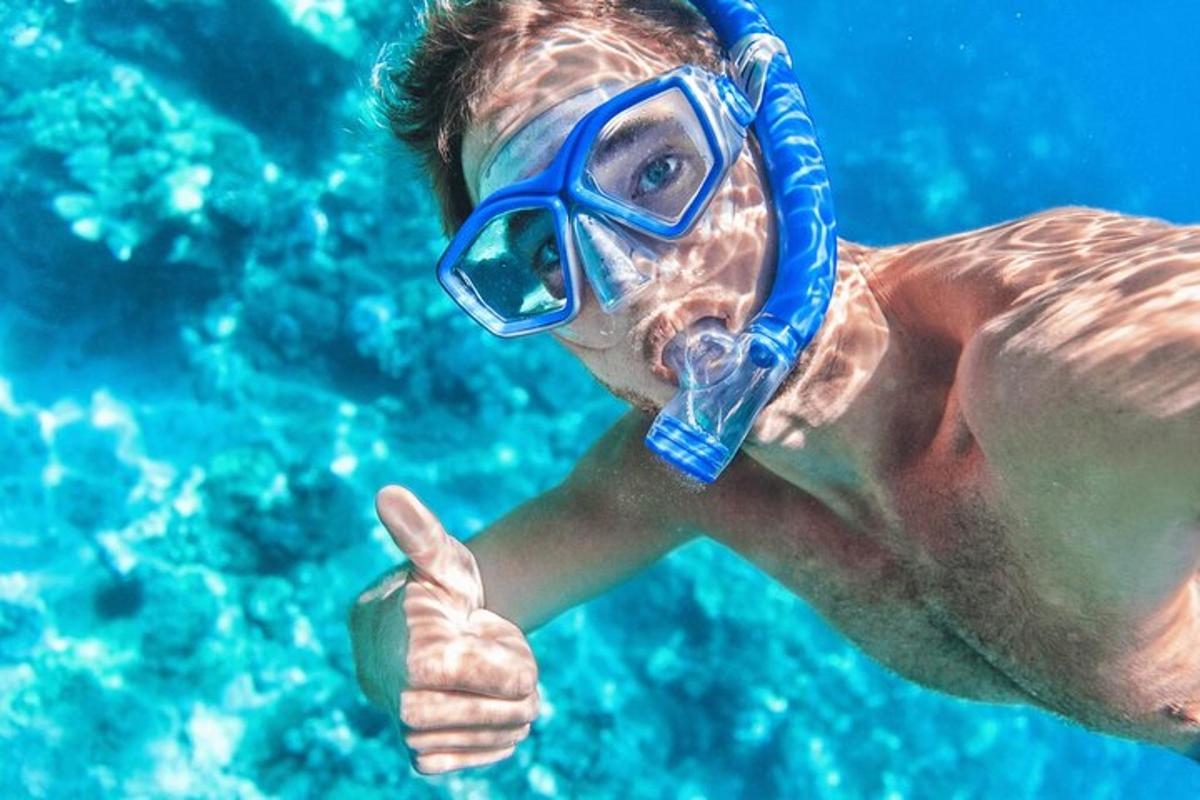 a man in a diver mask giving a thumbs up