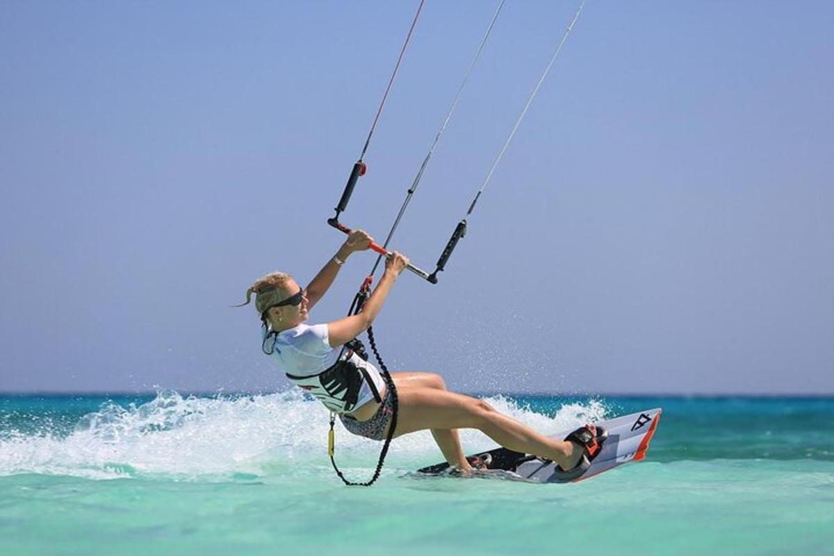 a woman is on a surfboard in the water