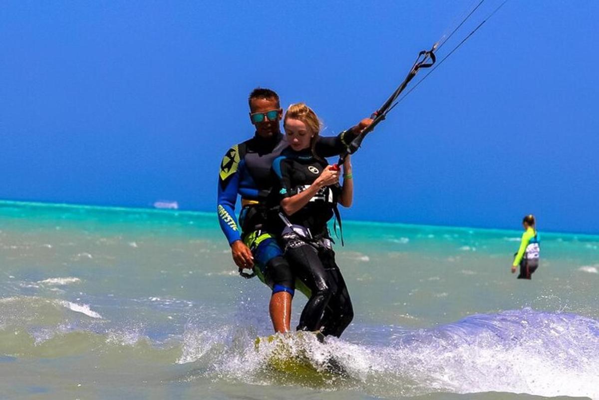 a man and woman water skiing in the ocean