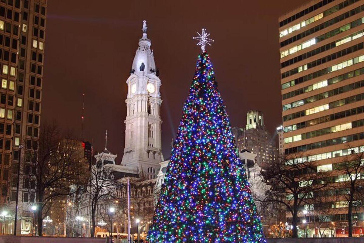 a christmas tree in a city with a clock tower