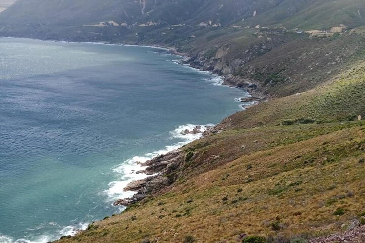 a view of the ocean from the side of a mountain