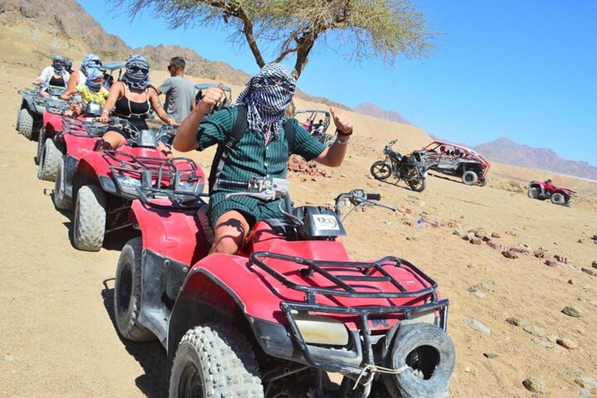 a group of people riding atvs in the desert