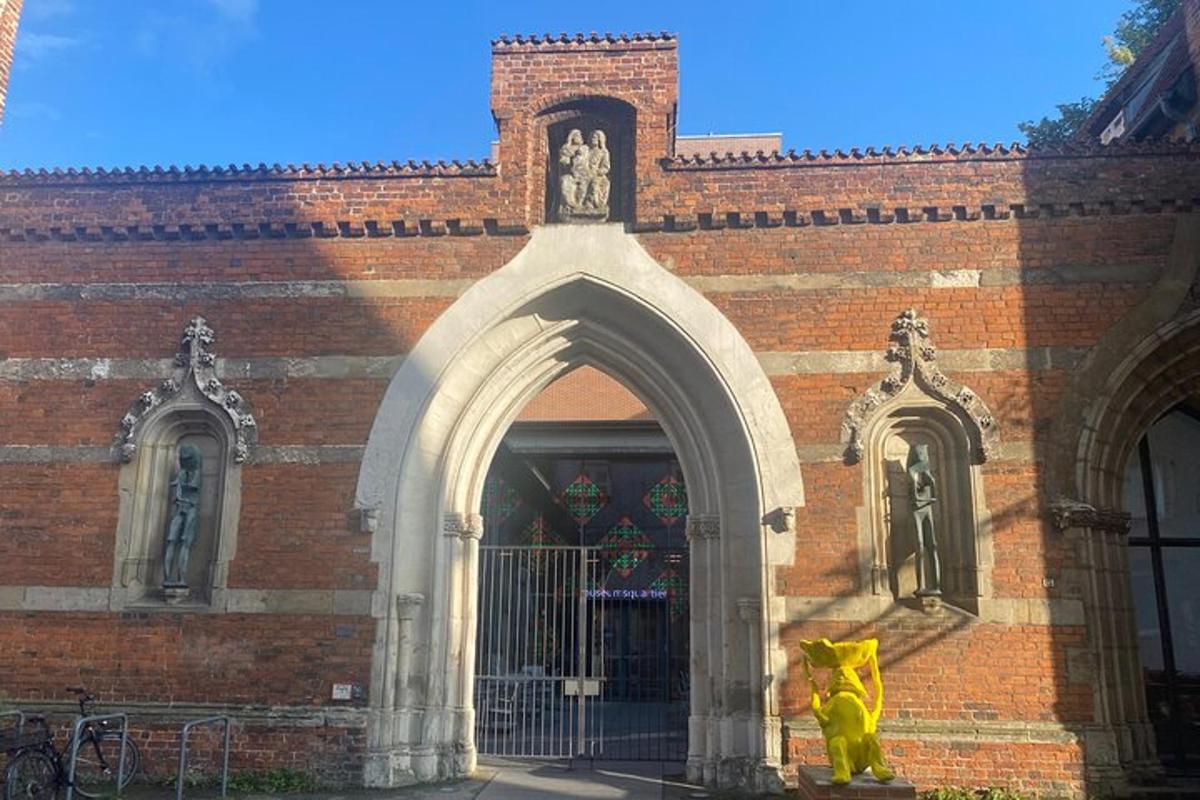 a building with a yellow statue in front of it