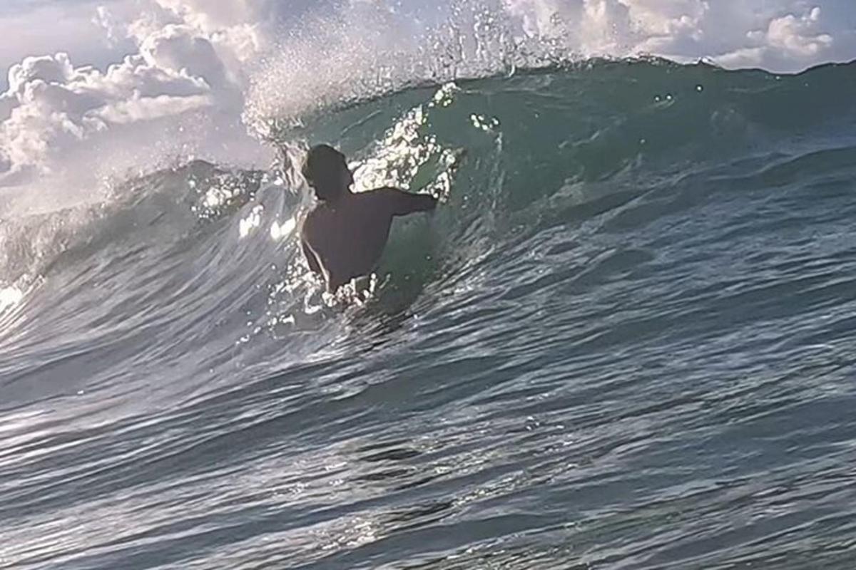a man riding a wave on a surfboard in the ocean