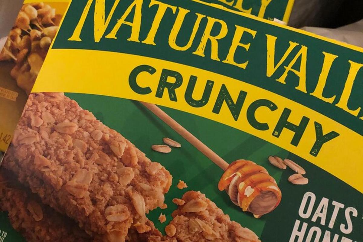 a box of nature milk crunch cereal with a stick in it